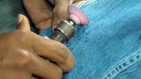 Making Destroyed Jeans Stock Footage 5199448