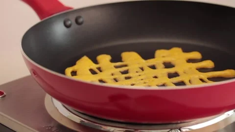 Making different figures in a cooking pan with scrambled eggs for a omelette Stock Footage 133814427