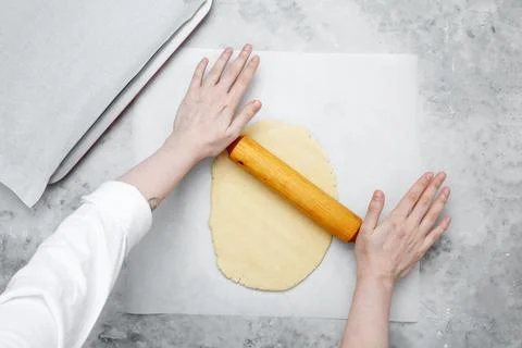 Making different shapes of fall cookies for Halloween. Woman rolling out doug Stock Photos