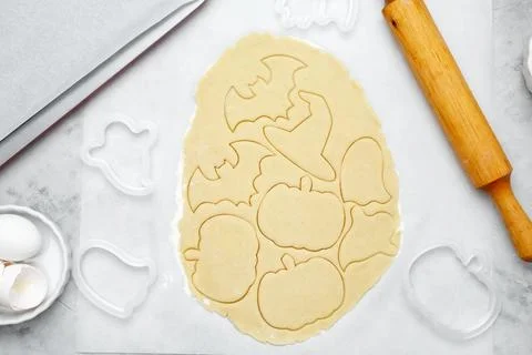 Making different shapes of fall cookies for Halloween. Dough with cookie cutt Stock Photos
