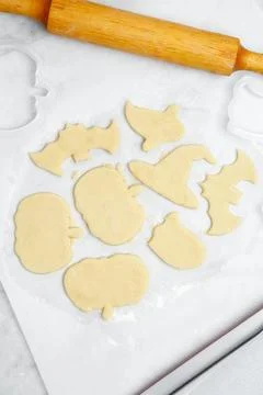 Making different shapes of fall cookies for Halloween. Dough with cookie cutt Stock Photos