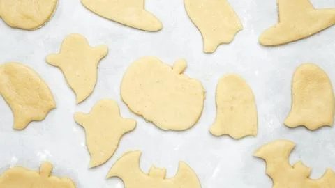 Making different shapes of fall cookies for Halloween. Dough with cookie cutt Stock Photos