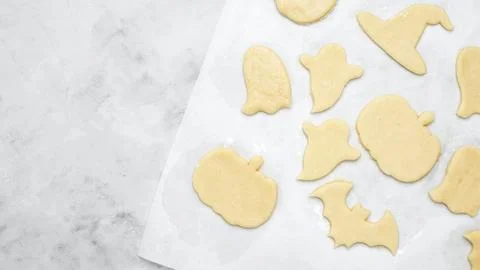 Making different shapes of fall cookies for Halloween. Dough with cookie cutt Stock Photos
