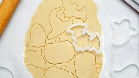 Making different shapes of fall cookies for Halloween. Dough with cookie cutt Stock Photos