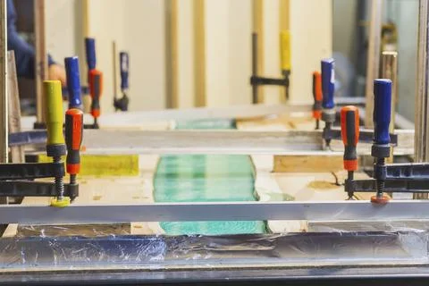 Making a dining table by oak and epoxy resin in the workshop Stock Photos