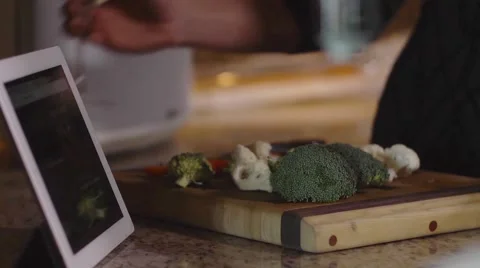 Making Dinner and Using Tablet Computer - iPad touchscreen Stock Footage 47780934
