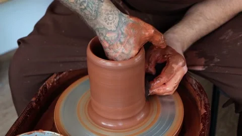 Making dishes on potter's wheel process, male hands in clay close-up Stock Footage 201285783