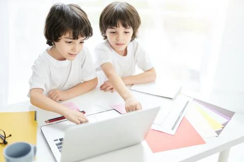 Making distance learning easy. Two adorable latin boys, brothers looking focused Foto stock