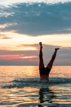 Making a dive into the water at the beach. Stock Photos