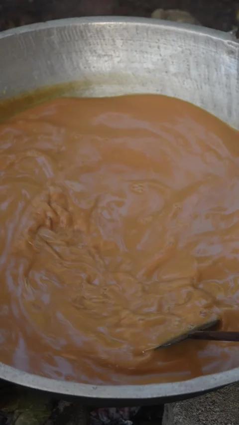 Making dodol in large container mixing with paddle Stock Footage 300930332