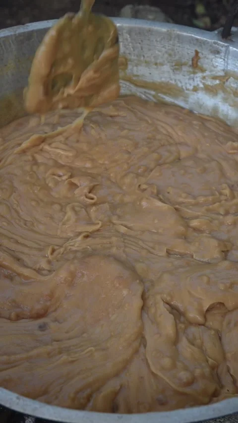 Making dodol in large container mixing with paddle Stock Footage 300930347