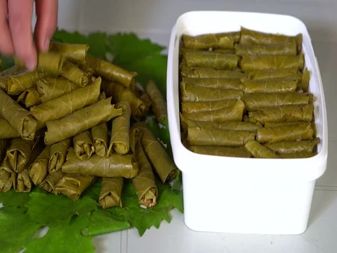 Making dolma, yaprak sarma, stuffed grape leaves, traditional turkish cuisine. Stock Footage 76202467