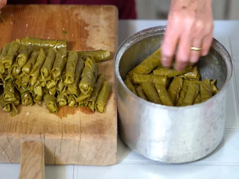 Making dolma, yaprak sarma, stuffed grape leaves, traditional turkish cuisine. Stock Footage 76648527
