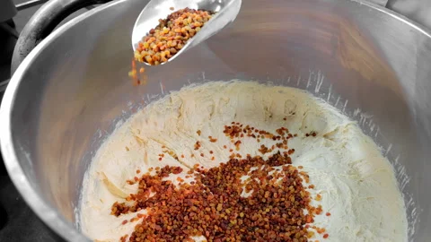 Making the dough and adding raisins. Making dough with raisins Stock Footage 242871546