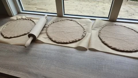 Making dough circles for a baking session at home 스톡 사진