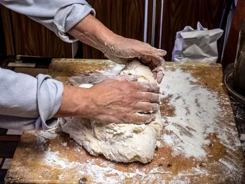 Making dough by hand with a view of a person's hands kneading the dough Stock Photos
