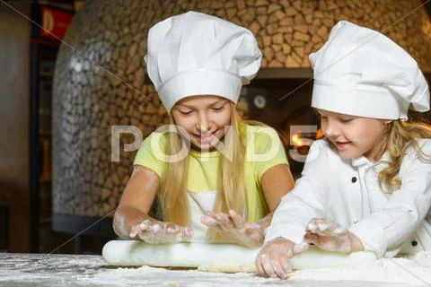 Making the dough for pizza is fun - little chefs playing with flour Stock Photos