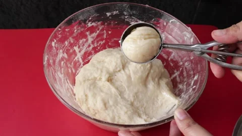 Making dough round balls by ice cream scoop Stock Footage 157529324