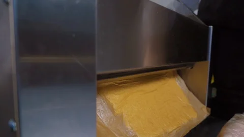 Making dough sheets. Rolled dough in a special culinary machine. Close-up Stock Footage 125956433