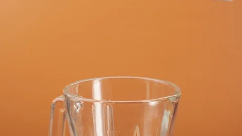 Making drink in blender. Two slices of fresh pineapple falling blender Stock Footage 125853097