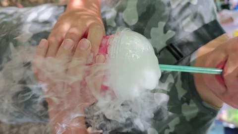 Making a drink with dry ice for fun at a picnic in the park in summer Stock Footage 339595165