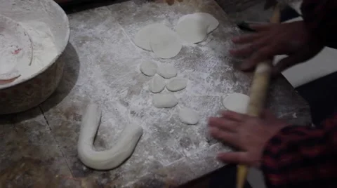 Making dumpling wrappers with rolling pin Stock Footage 46615597