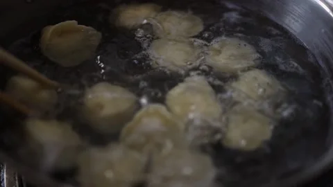Making dumplings and cooking dumplings at home  Stock Footage 229998089
