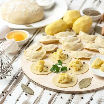 Making dumplings stuffed with mashed potatoes. Convenience Food. Cooking process Stock Photos