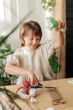 Making Easter decorations. A girl makes a textile Easter egg at home in the Stock Photos