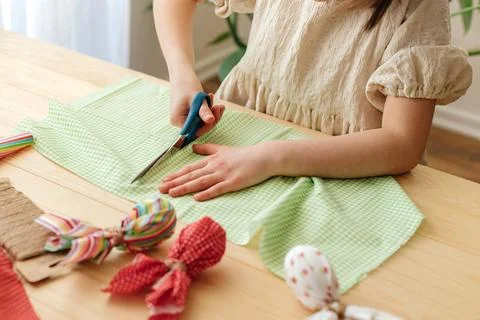 Making Easter eggs in the shape of a hare from textile. The girl prepares the Stock Photos