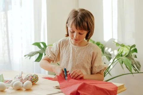 Making Easter eggs in the shape of a hare from textile. The girl prepares the Stock Photos