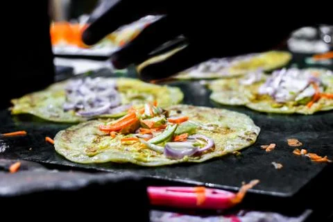 Making of egg roll on a hot frying pan with oil and paratha and salad 写真素材
