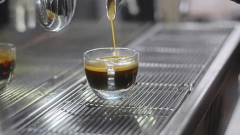 Making espresso coffee in a coffee machine and pouring to cup. Stock Footage 86259536