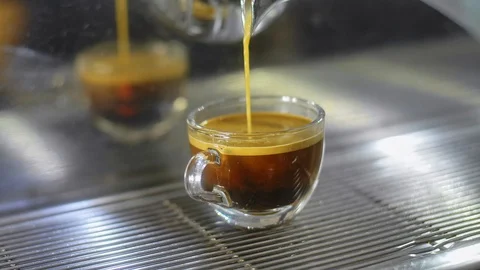 Making espresso coffee in a coffee machine and pouring to cup. Stock Footage 86260404
