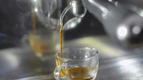 Making espresso coffee in a coffee machine and pouring to cup. Stock Footage 86260524