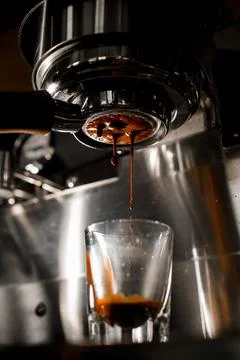 Making espresso on coffee machine through portafilter from arabica coffee Stock Photos