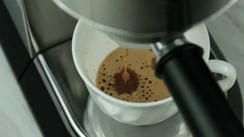 Making espresso in a coffee maker and pouring into a cup. Stock Footage 149595198