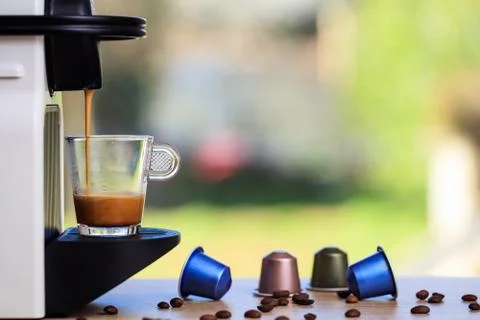 Making espresso. Espresso coffee maker on a wooden table. Blurred background, Stock Photos