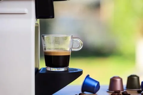 Making espresso. Espresso coffee maker on a wooden table. Blurred background, Stock Photos