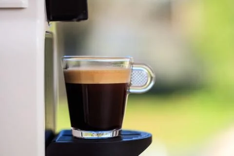 Making espresso. Espresso coffee maker on a blurred background, space for tex Stock Photos