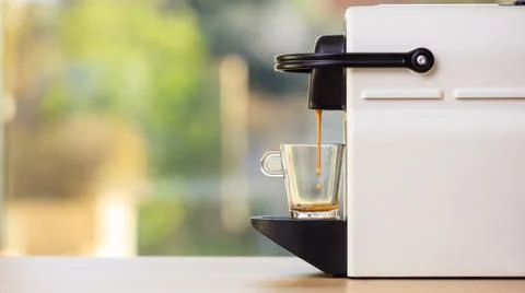 Making espresso. Espresso coffee maker on a wooden table. Blurred background, Foto stock