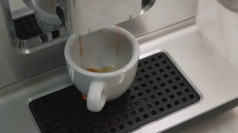 Making espresso in a white Cup from the automatic coffee machine Stock Footage 135183410