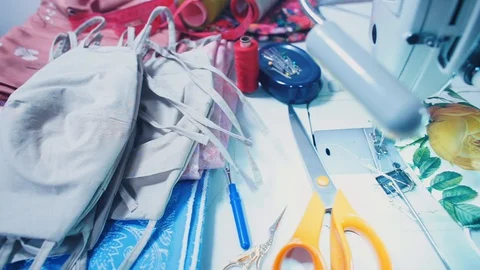 Making face masks on a sewing machine. COVID-19 Stock Footage 128164205