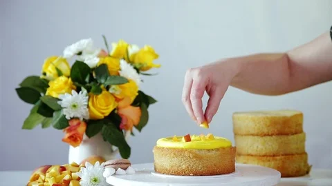 Making filling of the multilayered cake using yellow cream, pieces of fruits. Stock Footage 102042856