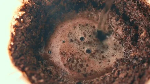 Making Filter Coffee. Water is poured thin stream circular motion into Ground Stock Footage 169655888