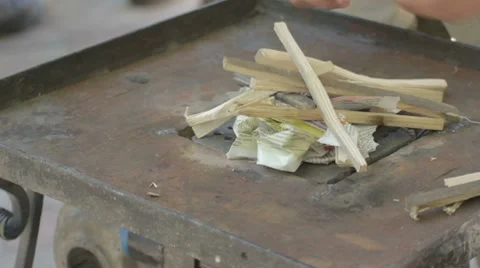 Making fire on forge table with paper and wood Stock-Footage 7769235