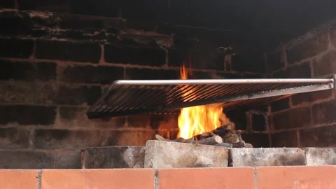 Making the fire to roast the meat Stock Footage 239108659
