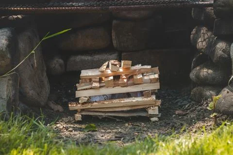 Making a fire using paper and small wood chips stacked in pyramid shapes to c Stock Photos