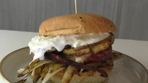 Making a fish sandwich with octopus, pineapple, endive, stracciatella Stock Footage 322989308