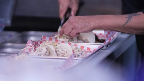 Making fish tacos at take out restaurant close up slow motion	 Stock Footage 122609711